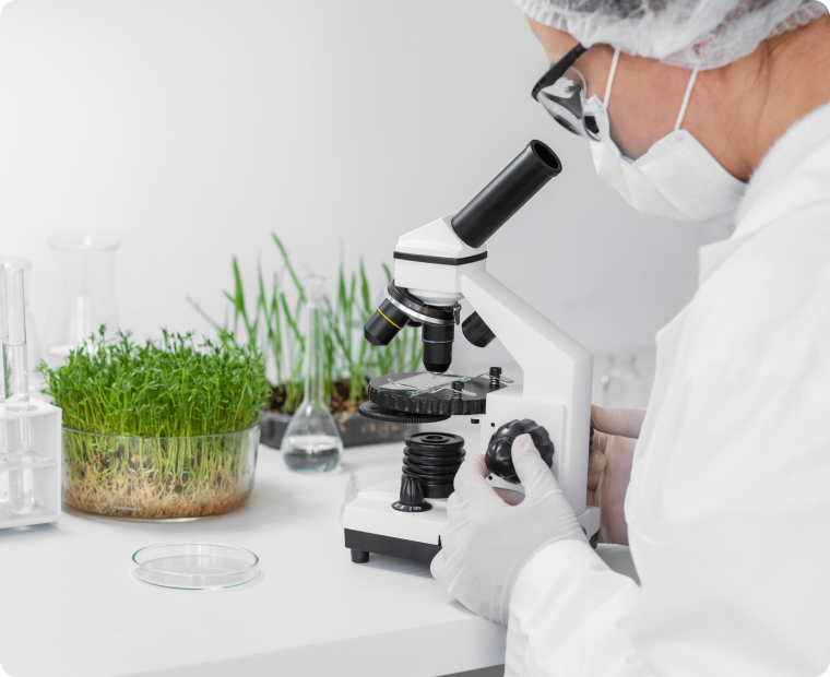 Researcher looking through microscope